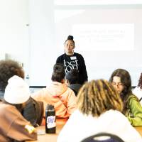 Girls of Color Summit previous event where people are sitting listening to a women speak